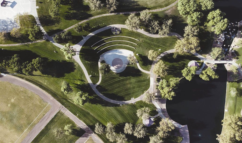 Aerial View of a Park with a Circular Pool and Grass